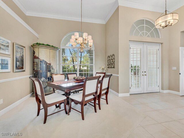 tiled dining space featuring crown molding, french doors, and a chandelier