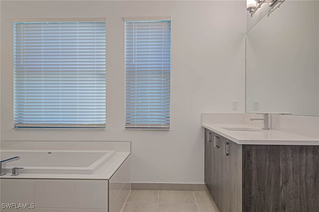 bathroom featuring a relaxing tiled tub, tile patterned floors, and vanity