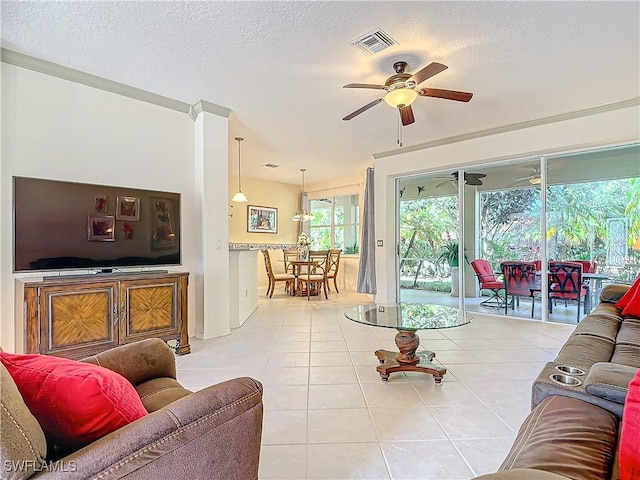 tiled living room with ceiling fan and a textured ceiling