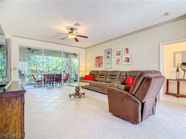 living room with light tile patterned flooring, ceiling fan, crown molding, and a textured ceiling