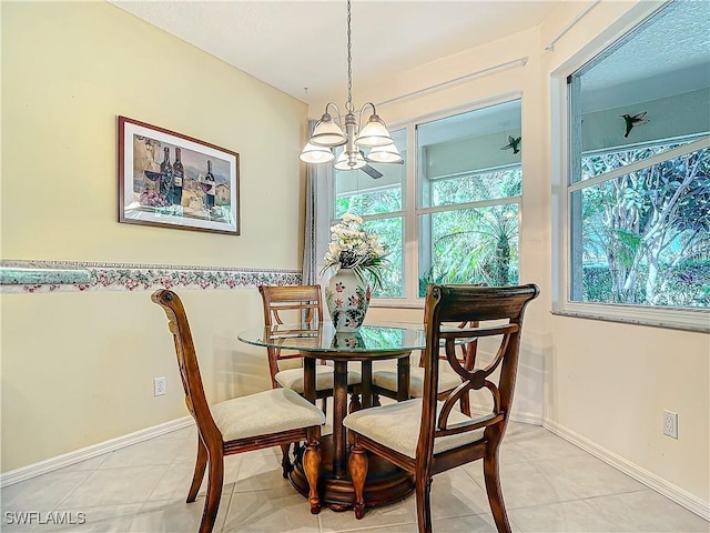 tiled dining space featuring a notable chandelier