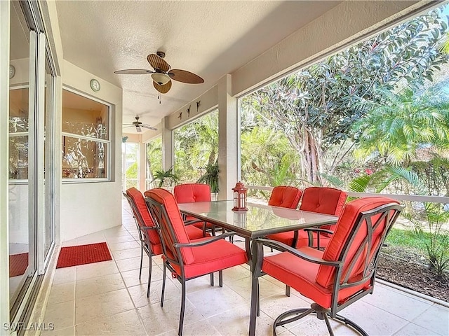 sunroom featuring ceiling fan