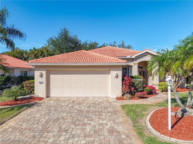 mediterranean / spanish-style house with a garage