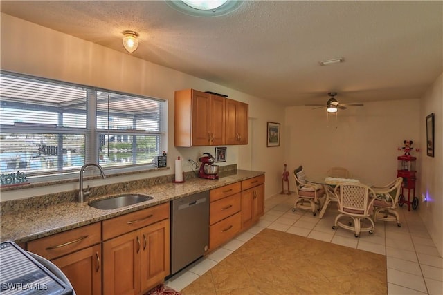 kitchen featuring dishwasher, sink, light tile patterned flooring, and ceiling fan