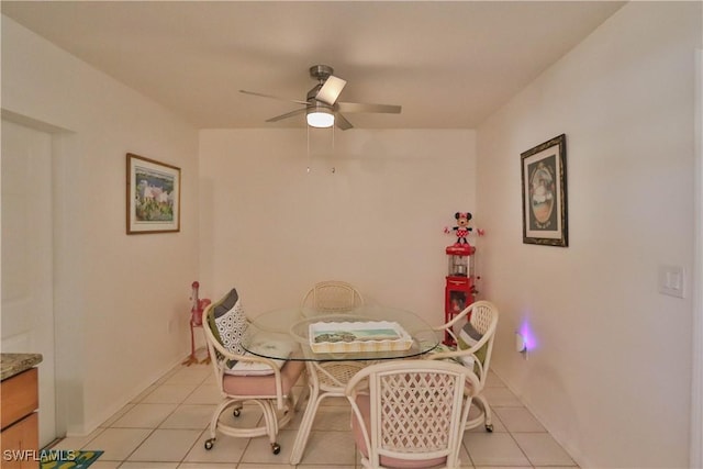 tiled dining area with ceiling fan