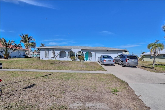 ranch-style house with a garage and a front lawn