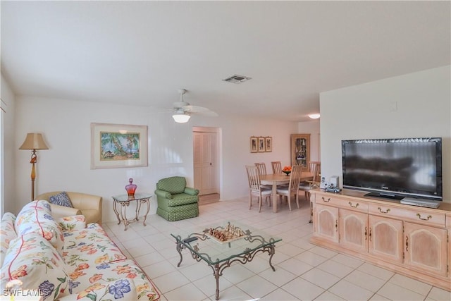 tiled living room featuring ceiling fan