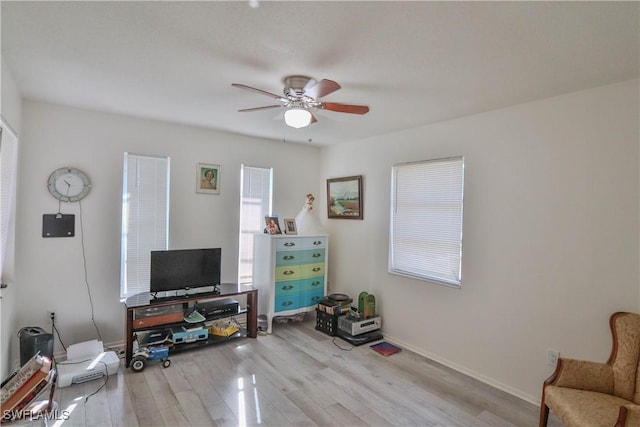 interior space with ceiling fan and light hardwood / wood-style floors