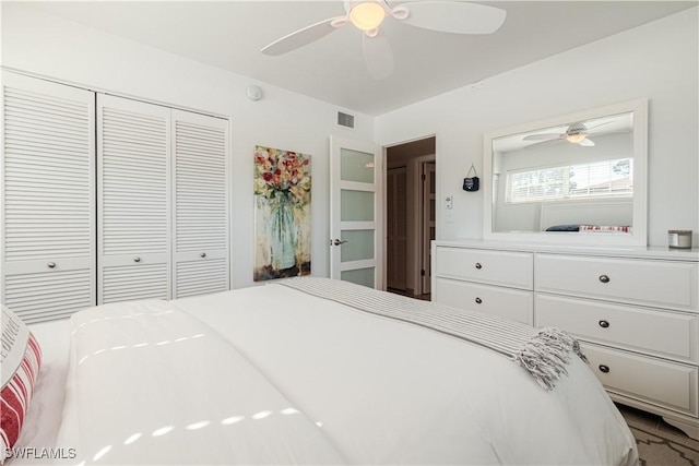 bedroom with ceiling fan and a closet