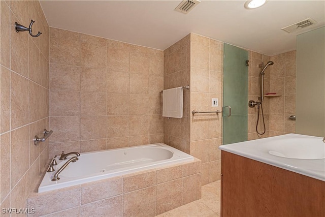 bathroom featuring shower with separate bathtub, tile walls, and vanity