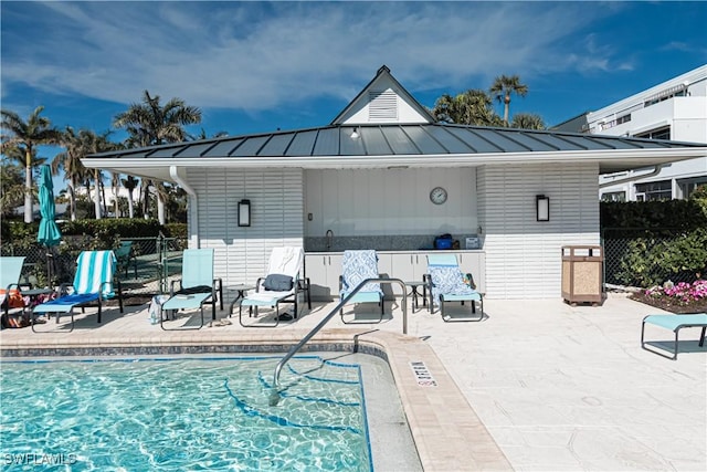 view of swimming pool with a patio and sink