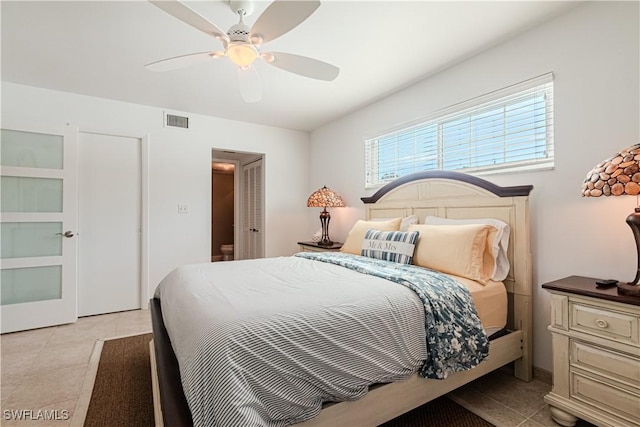 tiled bedroom with ceiling fan