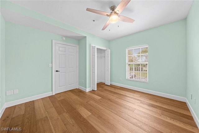 unfurnished bedroom with ceiling fan and light hardwood / wood-style flooring