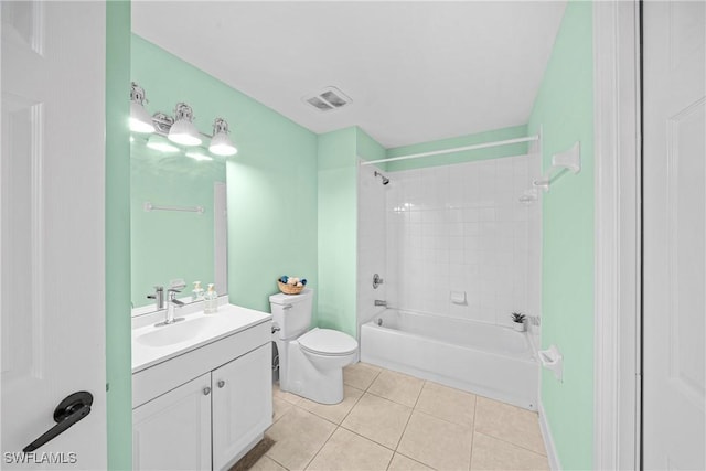 full bathroom featuring vanity, tile patterned floors, toilet, and tiled shower / bath