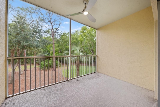 unfurnished sunroom with ceiling fan