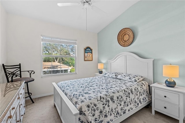 bedroom featuring vaulted ceiling, light colored carpet, and ceiling fan