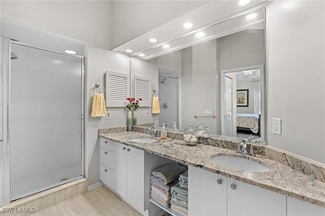 bathroom with vanity and a shower with shower door