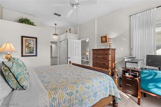 bedroom with vaulted ceiling, ceiling fan, carpet floors, and a closet