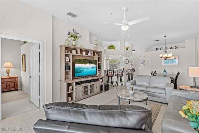 living room featuring ceiling fan with notable chandelier