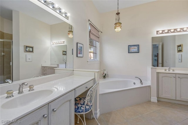 bathroom featuring a stall shower, tile patterned flooring, two vanities, and a sink