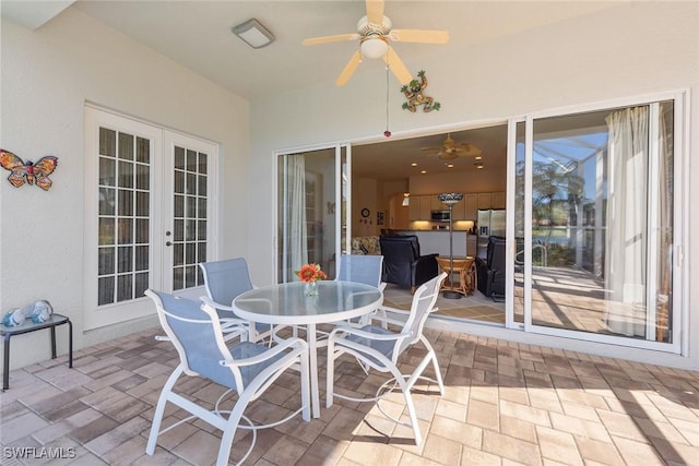 sunroom / solarium featuring a ceiling fan and french doors