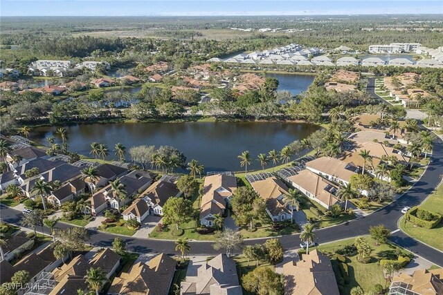 birds eye view of property with a water view and a residential view