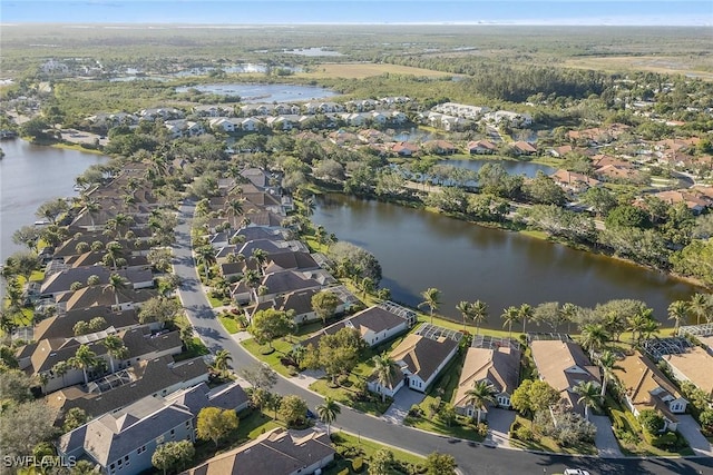 drone / aerial view featuring a water view and a residential view