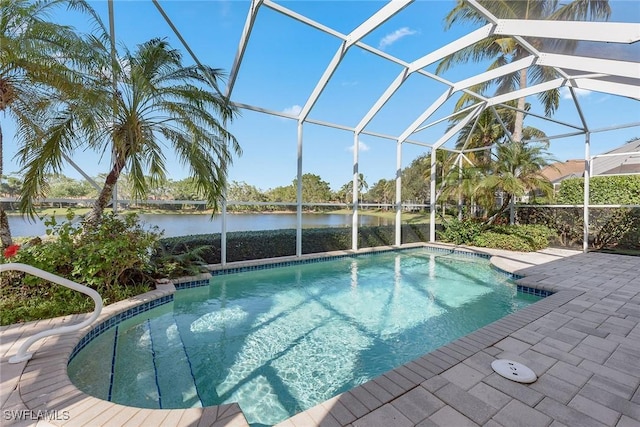 pool featuring a patio, a water view, and glass enclosure