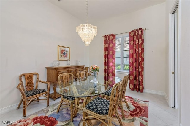 tiled dining area with a notable chandelier and baseboards