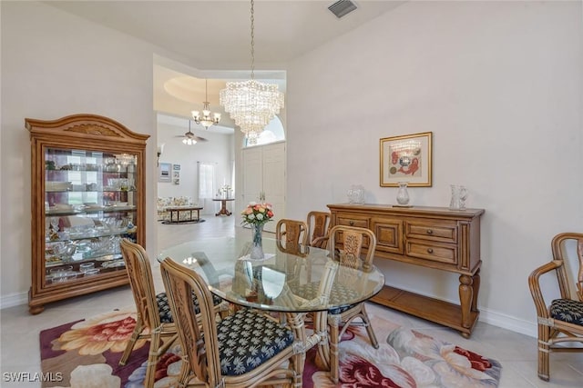 dining space featuring visible vents, a notable chandelier, baseboards, and light tile patterned flooring