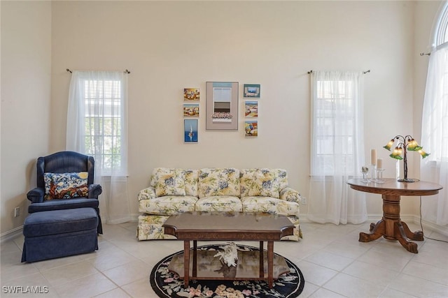 living room with plenty of natural light, baseboards, and tile patterned flooring
