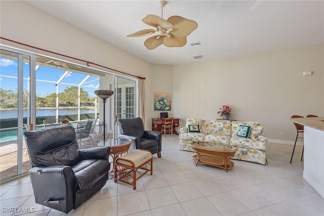 living area with ceiling fan, visible vents, a sunroom, baseboards, and light tile patterned flooring