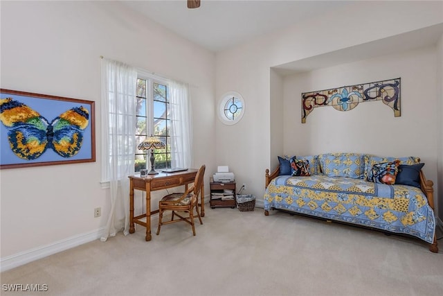 carpeted bedroom featuring baseboards and a ceiling fan