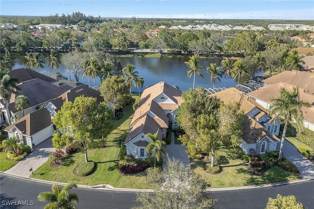 drone / aerial view with a water view and a residential view