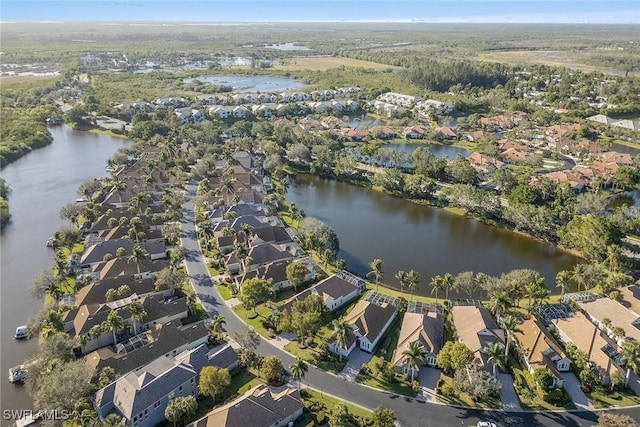 bird's eye view featuring a water view and a residential view