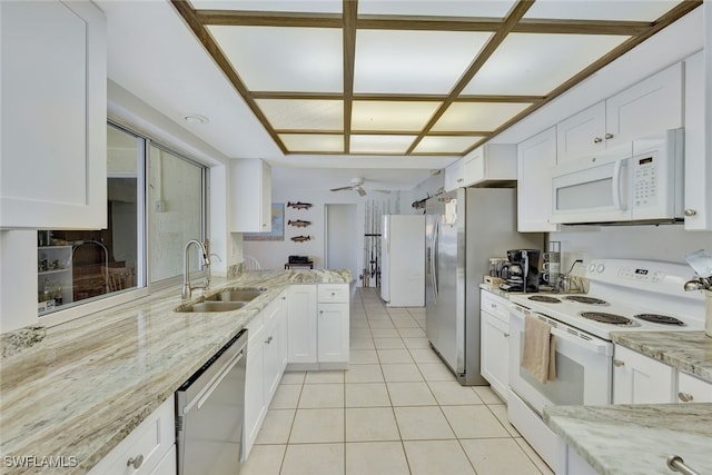 kitchen featuring appliances with stainless steel finishes, white cabinetry, and a sink