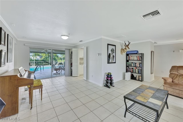 living area with a sunroom, visible vents, crown molding, and light tile patterned flooring