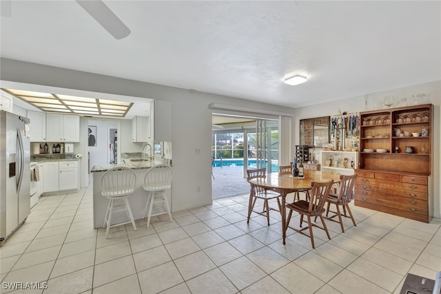 dining space with light tile patterned floors and baseboards