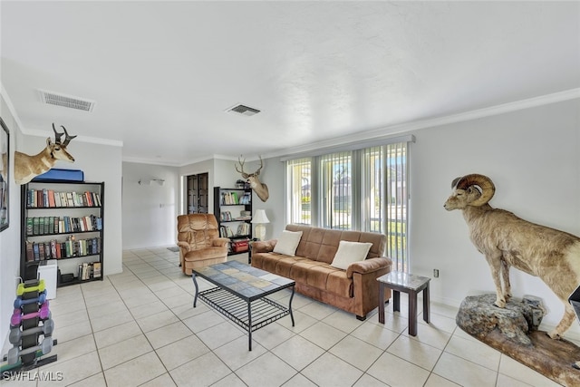 living area featuring light tile patterned floors, visible vents, and crown molding