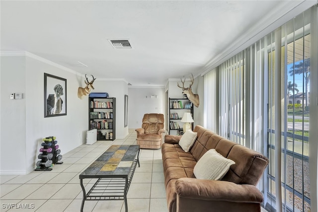 living area featuring light tile patterned floors, ornamental molding, visible vents, and baseboards