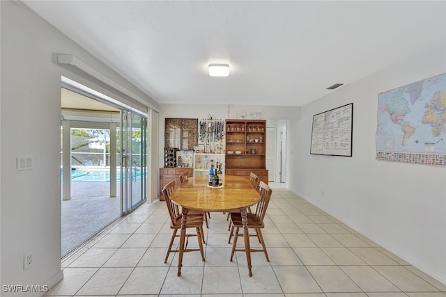 dining room with light tile patterned floors and visible vents