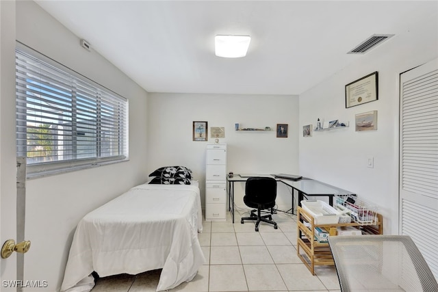 bedroom with light tile patterned floors and visible vents