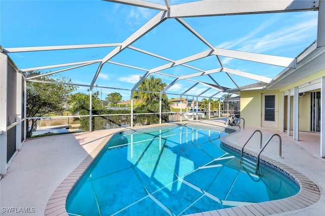 outdoor pool with a lanai and a patio area