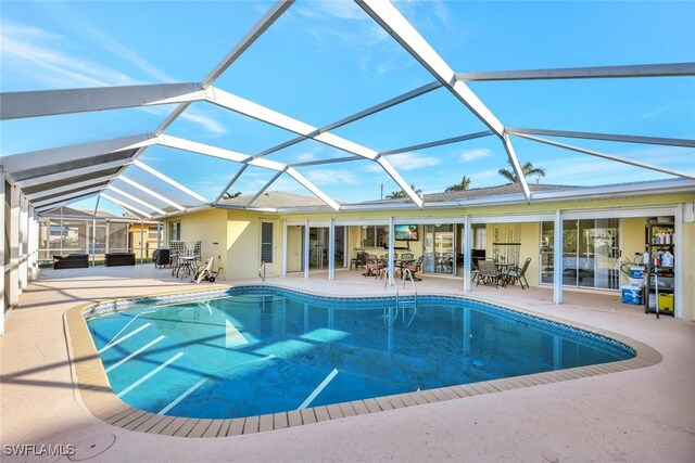 outdoor pool with a lanai and a patio