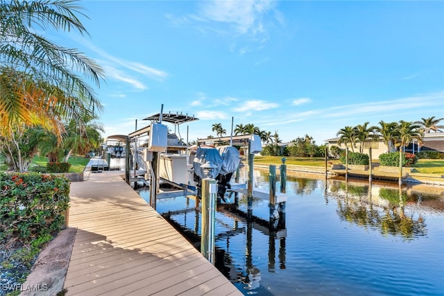 dock area with a water view and boat lift