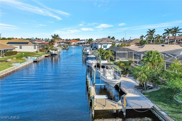 dock area with a residential view, a lanai, a water view, and boat lift