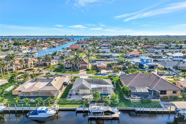 birds eye view of property with a water view and a residential view