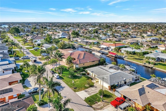 bird's eye view featuring a water view and a residential view