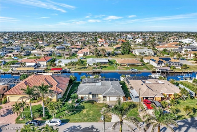 birds eye view of property with a water view and a residential view