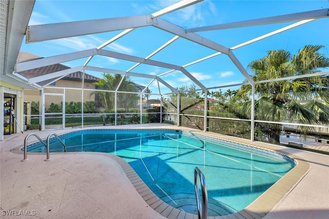 outdoor pool featuring a patio area and a lanai